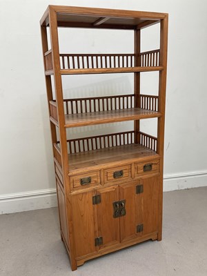 Lot 1044 - A Chinese elm freestanding shelf unit, with...