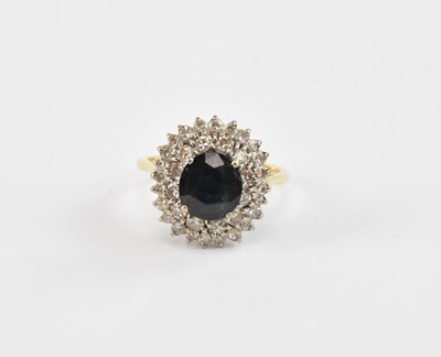 Lot 859 - An 18ct yellow gold ring set with a central...