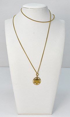 Lot 933 - A 9ct yellow gold circular award pendant dated...