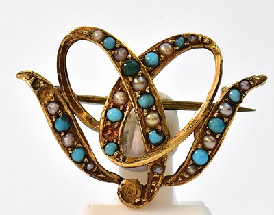 Lot 911 - An Edwardian 15ct yellow gold bow brooch set...