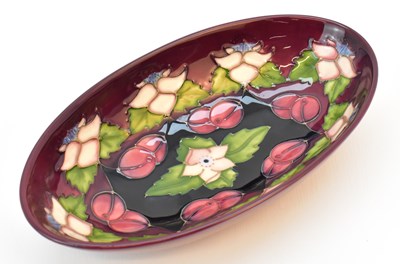 Lot 130 - MOORCROFT; an oval dish decorated in the...