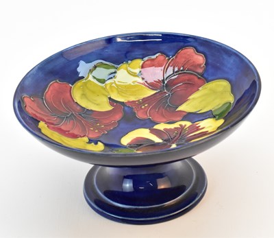 Lot 134 - MOORCROFT; a pottery pedestal fruit bowl,...