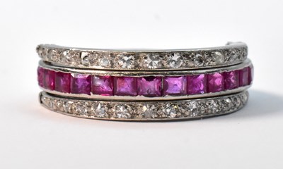 Lot 852 - A platinum day and night eternity ring, with...