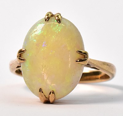 Lot 884 - A 9ct yellow gold opal set ring, the claw set...