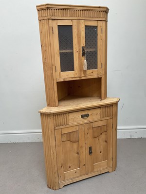 Lot 1260 - A pine free standing corner cupboard, with two...