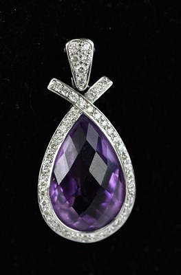 Lot 225 - A diamond and amethyst set oval shaped pendant,...