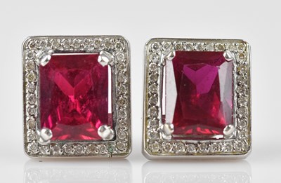 Lot 162 - A near pair of diamond and ruby ear studs, the...