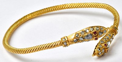 Lot 894 - A yellow metal rope textured bangle, the ends...