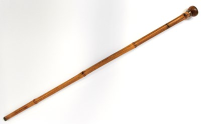 Lot 592 - A ‘blow pipe’ bamboo walking cane with wood...