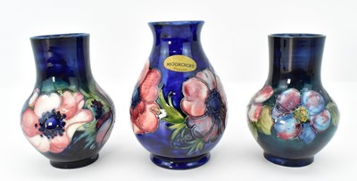 Lot 132 - MOORCROFT; three short pottery vases, each...