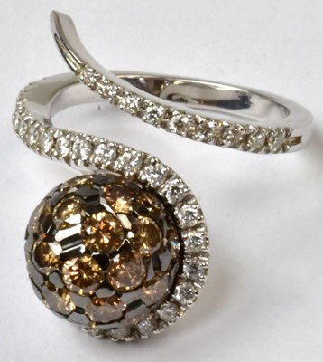 Lot 867 - A white metal open swirl ring, the shank set...