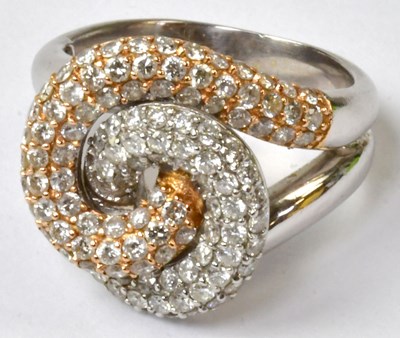 Lot 855 - An 18ct white and yellow gold double swirl...