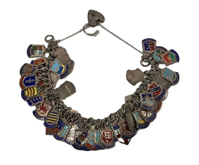 Lot 493 - A silver charm bracelet, each charm having an...