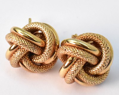 Lot 952 - A pair of 9ct yellow gold knot stud earrings,...