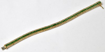 Lot 903 - A 14ct yellow gold tennis bracelet set with a...