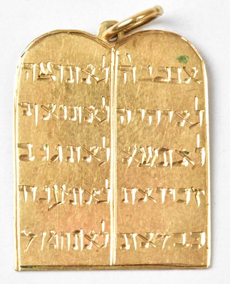 Lot 930 - A yellow metal Ten Commandments pendant,...