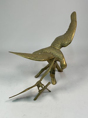 Lot 134 - A brass eagle perched on a branch, height 54cm,...