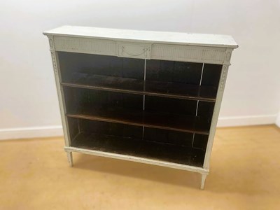 Lot 687 - A painted open bookcase having two adjustable...