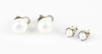 Lot 204 - Two pairs of pearl ear studs in white metal...