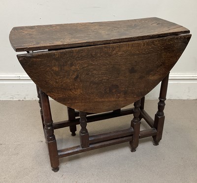 Lot 62 - An 18th century oak gateleg table, on turned...