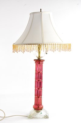 Lot 484 - A cranberry and clear glass table lamp, with...