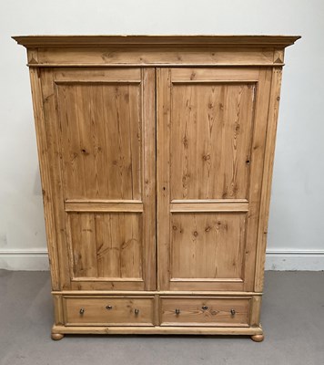 Lot 95 - A Continental pine wardrobe, with two panelled...