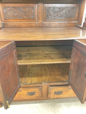 Lot 690 - A two piece oak Continental dresser, height...