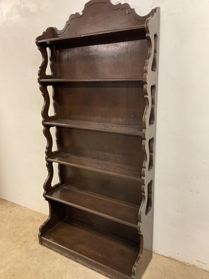 Lot 703 - A tall dark wood six tier freestanding...