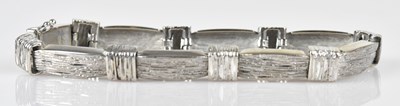 Lot 97 - A 9ct white gold textured gate link bracelet,...