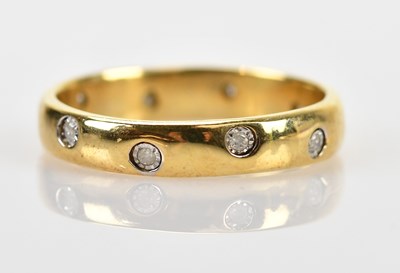 Lot 589 - A yellow metal diamond set wedding band, size...