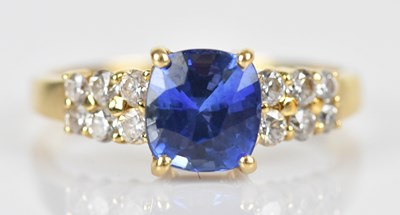Lot 600 - A diamond and Sri Lankan sapphire dress ring,...