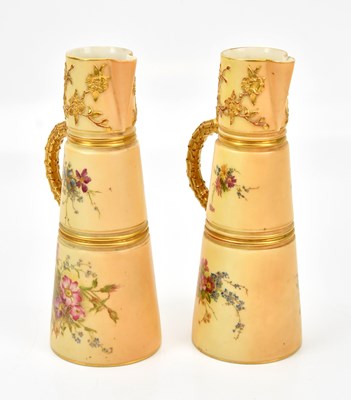 Lot 1345 - ROYAL WORCESTER; a pair of blush ivory jugs,...