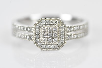 Lot 559 - A white metal diamond illusion set dress ring,...