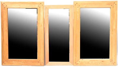 Lot 66 - A pair of large light oak wall mirrors, the...