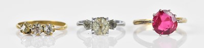Lot 599 - A synthetic ruby dress ring with oval cushion...