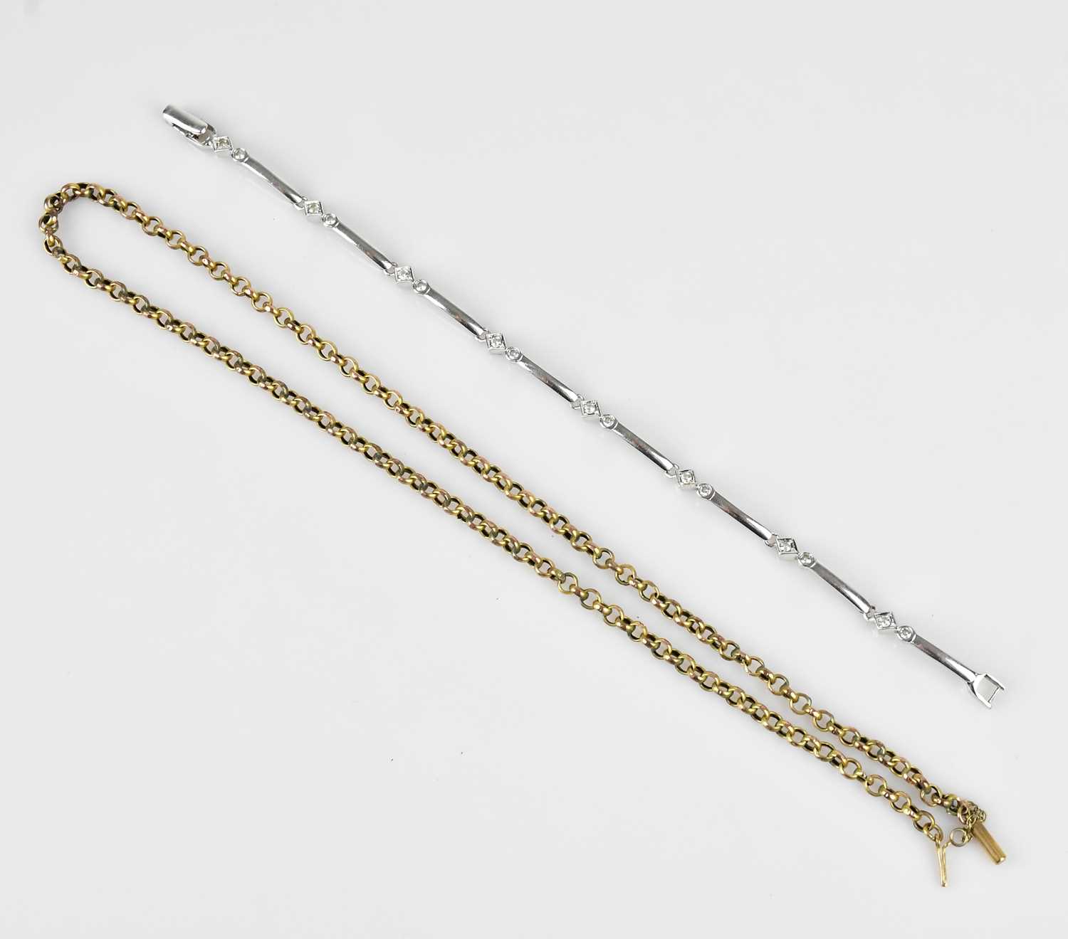 Lot 32 - A white metal bracelet set with clear stones,...