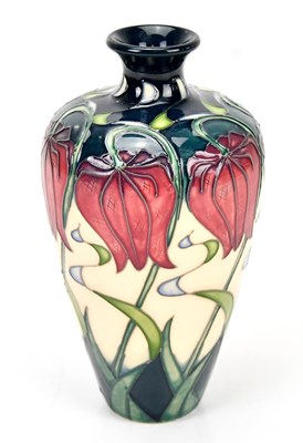 Lot 1364 - MOORCROFT; a floral decorated vase, height 15cm.
