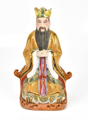 Lot 660 - A Chinese porcelain figure of seated deity,...