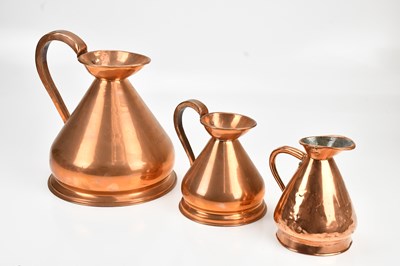 Lot 456 - A group of three graduated copper measuring...