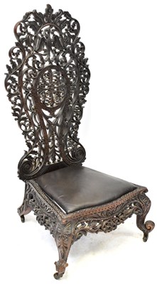 Lot 49 - An Anglo-Indian carved wooden high-back...