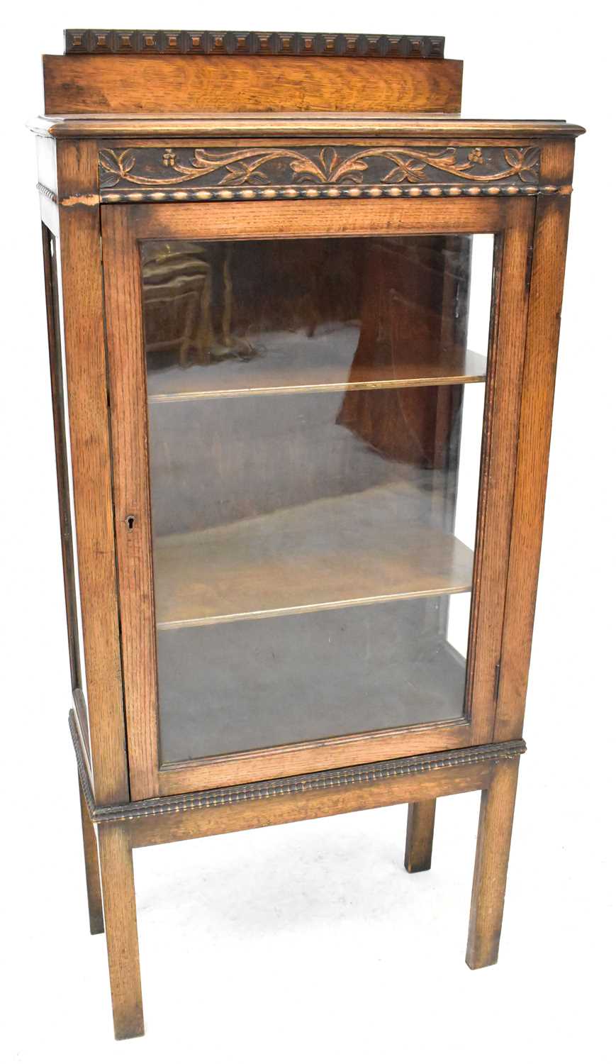 Lot 41 - An early 20th century oak display cabinet with...