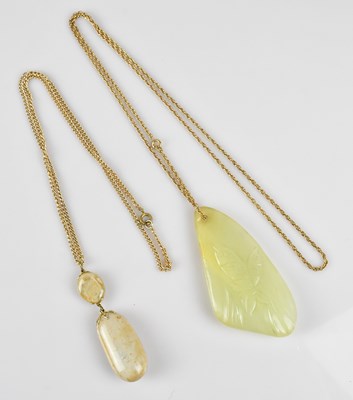 Lot 349 - A Chinese green hardstone pendant, decorated...