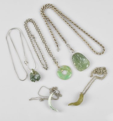Lot 649 - Four Chinese hardstone pendants on sterling...