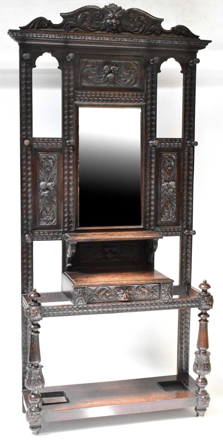 Lot 35 - A Victorian carved oak hall stand, the top...