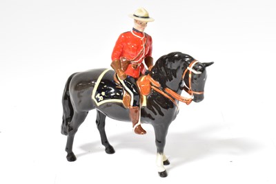 Lot 102 - BESWICK; a model of a Mountie on horseback,...