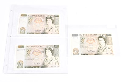 Lot 551 - THE BANK OF ENGLAND; three £50 bank notes,...