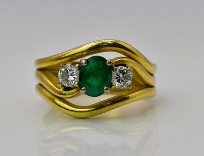 Lot 437 - An 18ct yellow gold emerald and diamond three...