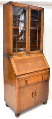 Lot 36 - A 1930s oak bureau bookcase, the leaded glazed...