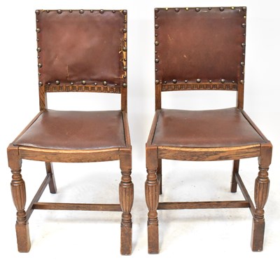 Lot 10 - A 1930s oak refectory-style extending dining...
