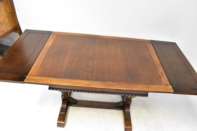 Lot 10 - A 1930s oak refectory-style extending dining...